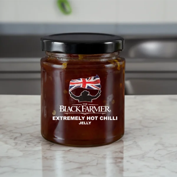 A jar of The Black Farmer’s Extremely Hot Chilli Jelly, featuring a deep red jelly with vibrant chillies on the label.