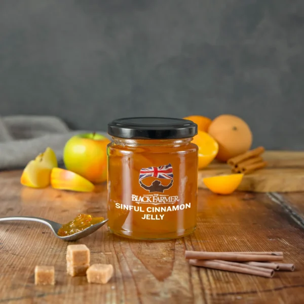 A jar of The Black Farmer’s Sinful Cinnamon Jelly, with a warm amber jelly and cinnamon sticks illustrated on the label.