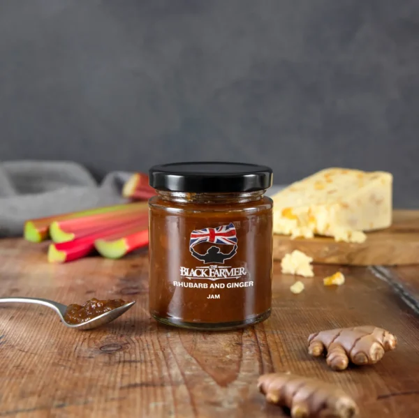 A jar of The Black Farmer’s Rhubarb and Ginger Jam, with a label featuring rhubarb stalks and ginger roots.